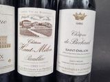 three bottles of wine are lined up in a row on a table