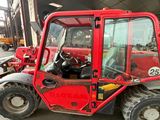 a red fork truck parked in front of a building