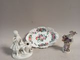 two figurines sitting next to each other on a table