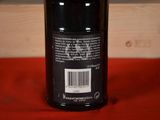 a bottle of wine sitting on a red table cloth