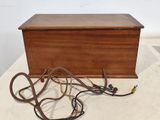 a small wooden box with wires on a table