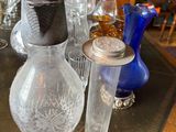 many glass vases on a table with a blue vase