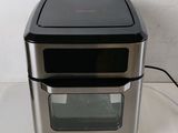 a silver and black oven sitting on a white counter