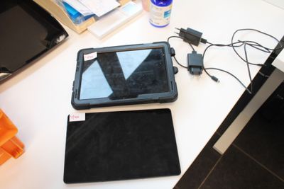 a tablet computer sitting on top of a desk next to a monitor