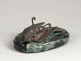 statue of a bird on a rock with a white background