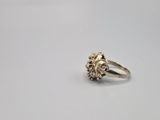 a close up of a gold ring with a flower on it
