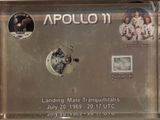 a picture of a plaque with a picture of astronauts on it
