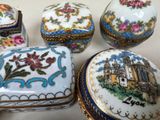a group of small boxes with flowers and a castle on them