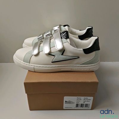 a box with a pair of white shoes on it