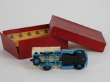 a small toy train in a red box on a white surface