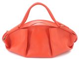 an orange leather handbag on a white background