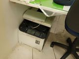 a desk with a printer and a phone on it