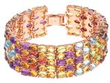 un gros plan d'un bracelet orné de pierres multicolores sur fond blanc