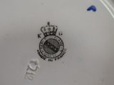 a close up of a plate with a crown on it