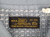 a close up of a blue sweater with a label on it
