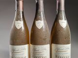 three bottles of wine sitting on a table next to each other
