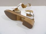 pair of white sandals on a white table with a white background