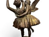 bronze statue of a ballerina and a fairy on a pedestal
