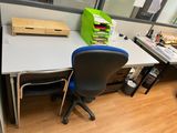 a desk with a chair and a computer on it