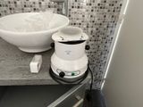 a blender sitting on a counter next to a bowl of water