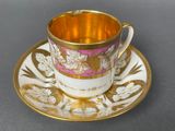 a cup and saucer on a saucer on a table