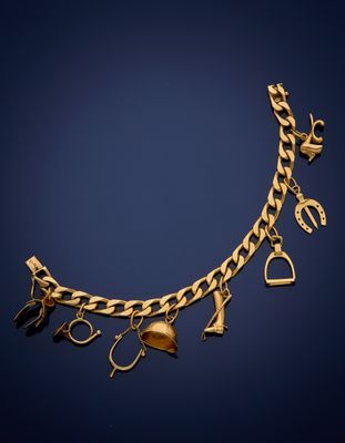 a gold bracelet with charms and a heart on it