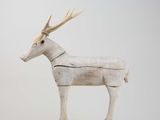 sculpture of a white deer with antlers on it ' s head