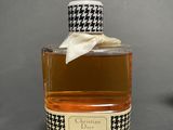 a bottle of perfume with a bow on it