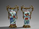 pair of chinese vases with floral designs and gilded handles