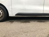 a white van that is parked on the side of the road