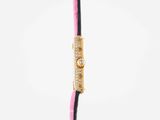 the pink and black bracelet has a gold clasp on the end of it