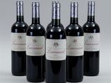 four bottles of wine are lined up in a row
