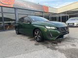 a green car parked in front of a building