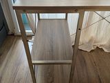 a wooden table with a bench on it in front of a window