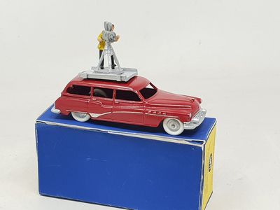 a red toy car with a man on top of it