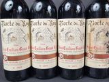 four bottles of wine are lined up on a table