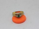 a gold ring with a green and white stone on it