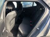 the back seat of a car with the door open in a parking lot