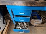 a lot of tools in a blue drawer on a workbench