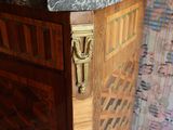 a wooden cabinet with a marble top in a room