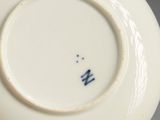 a close up of a white plate with a blue design on it