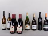 bottles of wine are lined up in a row on a table