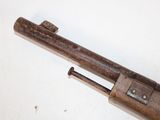 an old gun with a wooden handle on a white surface