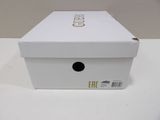 a white box that has a gold logo on it