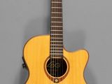 a close up of an acoustic guitar on a gray background