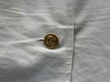 a close up of a button on a white shirt