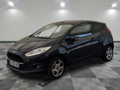 the black ford fiesta is parked on a checkered tile floor