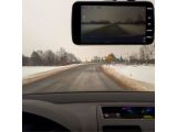 dashboard view of a car driving down a snow covered road