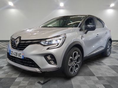 the front of a white car is parked in a room
