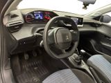the interior of a small car with a steering wheel and dashboard